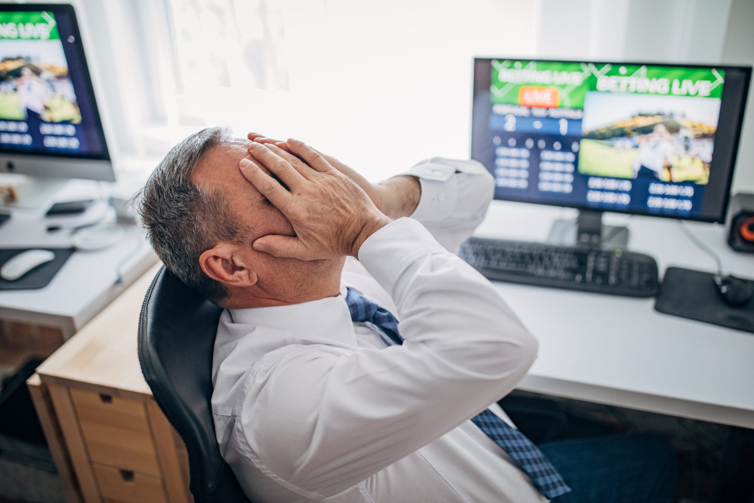 One senior business man live betting at his home office and lose game