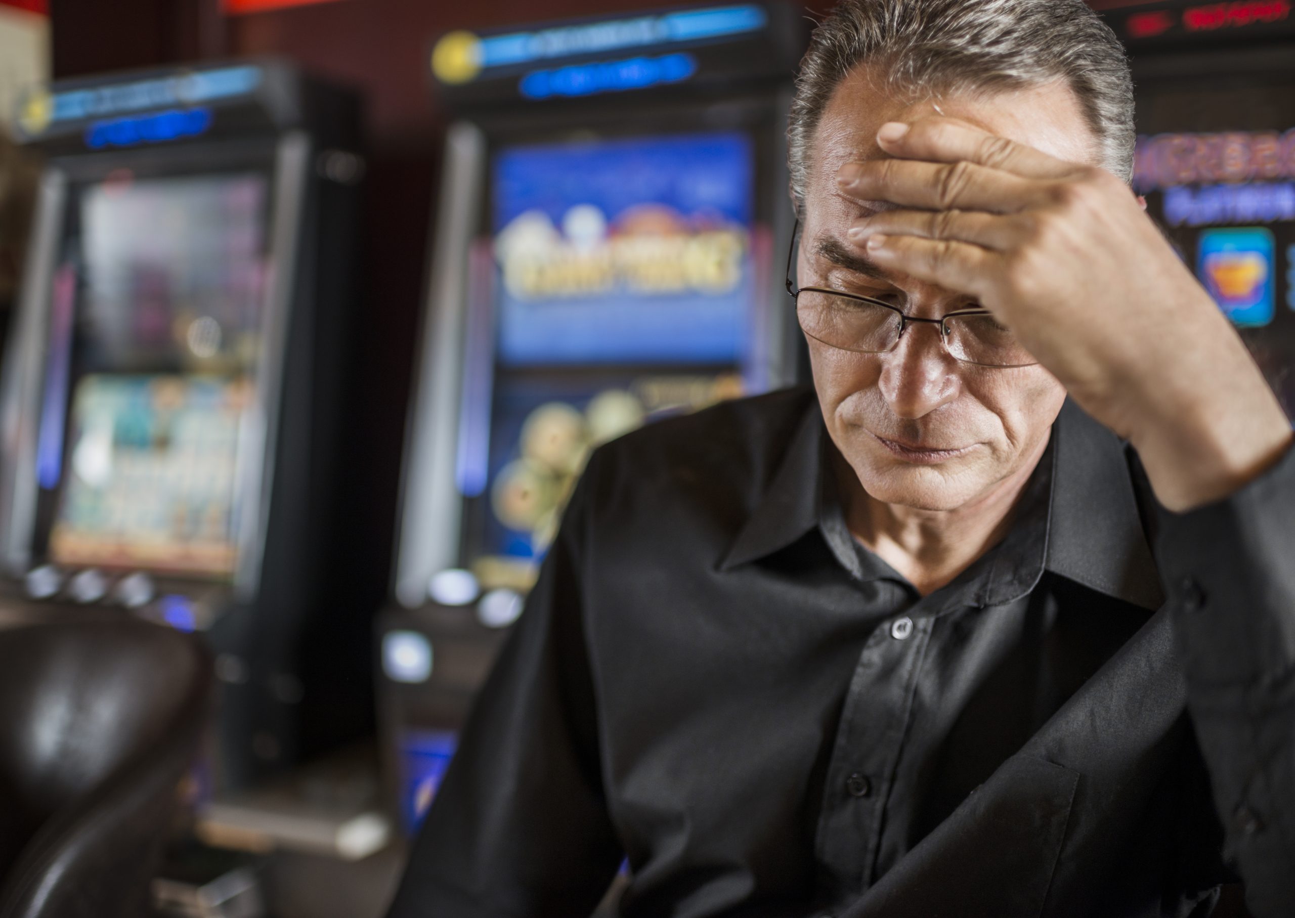 Depressed man worried after loosing his money on gambling.